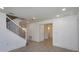 Spacious living room featuring tile flooring, staircase, and doorway leading to bathroom at 1518 Fabian Ave, Orlando, FL 32807