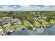 An aerial view showcases waterfront homes with lush landscaping and private docks at 1606 The Oaks Dr, Maitland, FL 32751