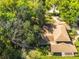 Aerial view showcasing a spacious home surrounded by lush greenery and mature trees at 1606 The Oaks Dr, Maitland, FL 32751