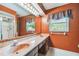 Well-lit bathroom with a double sink vanity, a large mirror, and a glass-enclosed shower at 1606 The Oaks Dr, Maitland, FL 32751