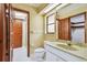 Bathroom featuring tiled floor, marble top sink, and wood trim at 1606 The Oaks Dr, Maitland, FL 32751