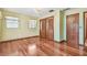 Bright bedroom features hardwood floors, neutral walls, and classic wood trim at 1606 The Oaks Dr, Maitland, FL 32751