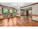 Formal dining room with hardwood floors, decorative wallpaper, and a stylish chandelier at 1606 The Oaks Dr, Maitland, FL 32751