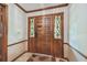 Elegant front door with decorative glass sidelights and detailed woodwork at 1606 The Oaks Dr, Maitland, FL 32751