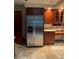 Kitchen area featuring stainless steel refrigerator and stainless steel appliances with custom wood cabinets at 1606 The Oaks Dr, Maitland, FL 32751