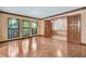 Living room featuring hardwood floors, dark trim, large windows, and lots of natural light at 1606 The Oaks Dr, Maitland, FL 32751