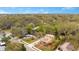 Aerial view of the neighborhood showcasing mature trees and a charming yellow home at 1920 S Palmetto Ave, Sanford, FL 32771