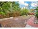 Fenced backyard with a brick-lined walkway, seating area, and mature bamboo for privacy at 1920 S Palmetto Ave, Sanford, FL 32771