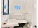 Bright bathroom with subway tile, window and a black clawfoot tub at 1920 S Palmetto Ave, Sanford, FL 32771