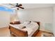 Bright bedroom with a large window, a bed, ceiling fan and hardwood floors at 1920 S Palmetto Ave, Sanford, FL 32771