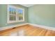 Bedroom with neutral walls, hardwood floors, and a window with view of sky and trees at 1920 S Palmetto Ave, Sanford, FL 32771