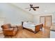 Cozy bedroom with a ceiling fan, hardwood floors and natural light from double doors to the deck at 1920 S Palmetto Ave, Sanford, FL 32771