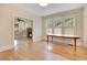 Sunlit dining room with hardwood floors, a classic table, and views into the fireplace room at 1920 S Palmetto Ave, Sanford, FL 32771