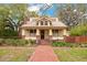 Charming home featuring a brick walkway, well-maintained landscaping, and cozy front porch at 1920 S Palmetto Ave, Sanford, FL 32771