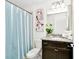 Bathroom featuring a shower-tub combination with a stylish blue curtain at 2004 Summer Dr, Davenport, FL 33897