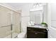 Bathroom with a tiled shower and dark cabinets at 2004 Summer Dr, Davenport, FL 33897