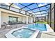 Beautiful screened-in pool and spa with plenty of space to relax and enjoy the outdoors at 2004 Summer Dr, Davenport, FL 33897