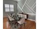 Stylish dining room with a glass table, gray accent wall, and decorative wall paneling at 202 Stargrass Dr, Auburndale, FL 33823