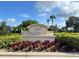 The 'Wateridge' entrance sign is surrounded by colorful plants, lush shrubs and manicured trees at 202 Stargrass Dr, Auburndale, FL 33823