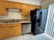 This kitchen features a stainless steel dishwasher, black refrigerator, and double basin sink at 218 Perth Ct # A, Winter Springs, FL 32708