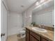 Bathroom with neutral-toned tile, a white bathtub and shower, and a dark wood vanity at 248 Carina Cir, Sanford, FL 32773