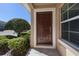 Inviting front entrance with a paneled front door and lush landscaping at 248 Carina Cir, Sanford, FL 32773