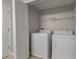 Laundry room with a white washer and dryer, wire shelving, and tile floors for easy maintenance at 248 Carina Cir, Sanford, FL 32773