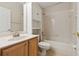 Bathroom features a bathtub, shower, wood cabinets, and sink at 2582 Greenwillow Dr, Orlando, FL 32825