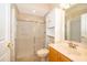 A bathroom featuring a glass enclosed shower, toilet, and a light wood vanity at 2582 Greenwillow Dr, Orlando, FL 32825