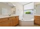 This bathroom features a large soaking tub, window and dual sinks at 2582 Greenwillow Dr, Orlando, FL 32825