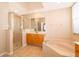 Bright bathroom with large tub, glass shower, and spacious vanity at 2582 Greenwillow Dr, Orlando, FL 32825