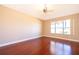 Serene bedroom with wood floors, ceiling fan, and natural light from a large window at 2582 Greenwillow Dr, Orlando, FL 32825