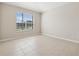 Sunlit bedroom features neutral walls, tile floors, and a large window with great outdoor views at 2582 Greenwillow Dr, Orlando, FL 32825