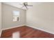 Empty bedroom features a ceiling fan, window and hardwood floors at 2582 Greenwillow Dr, Orlando, FL 32825