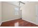 Bedroom with ceiling fan, window, wood floors, and white trim at 2582 Greenwillow Dr, Orlando, FL 32825