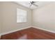 Bedroom featuring wood floors, ceiling fan, and bright window at 2582 Greenwillow Dr, Orlando, FL 32825