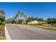 Community entrance with stone signage and mature landscaping, palm trees, and well-maintained greenery at 2582 Greenwillow Dr, Orlando, FL 32825