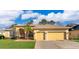 Charming single-story home with a three-car garage and a well-maintained lawn at 2582 Greenwillow Dr, Orlando, FL 32825