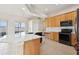 This bright kitchen features marble countertops, wood cabinets, stainless appliances and a breakfast bar island at 2582 Greenwillow Dr, Orlando, FL 32825