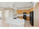 This bright kitchen features marble countertops, wood cabinets, stainless appliances and a large kitchen island at 2582 Greenwillow Dr, Orlando, FL 32825