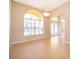 Inviting living room features tile flooring, large arched window and double-door entry at 2582 Greenwillow Dr, Orlando, FL 32825