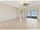 A neutral, bright living room shows an open floor plan with tile floors and sliding glass doors to the outside at 2582 Greenwillow Dr, Orlando, FL 32825