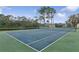 A view of the community tennis court with a view of the lake at 2582 Greenwillow Dr, Orlando, FL 32825