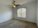 Bedroom with a ceiling fan, neutral carpet, and a large window at 2634 Rutledge Ct, Winter Haven, FL 33884