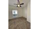 Bright bedroom featuring carpet flooring, ceiling fan, and natural light from the window at 2634 Rutledge Ct, Winter Haven, FL 33884