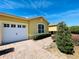 Exterior view of single-story home with two-car garage and charming brick paved driveway at 2634 Rutledge Ct, Winter Haven, FL 33884