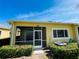 Exterior rear patio view of the home with manicured landscaping and a partial sky view at 2634 Rutledge Ct, Winter Haven, FL 33884