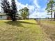 Spacious backyard featuring a chain link fence, lush trees, and access to waterfront views for a serene living at 2674 Kingsdale Dr, Deltona, FL 32738