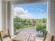 Balcony with seating featuring views of the parking lot and trees at 3175 Feltrim Pl # 304, Kissimmee, FL 34747