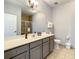 Neutral bathroom with gray vanity, white countertop and a glass-enclosed shower at 3175 Feltrim Pl # 304, Kissimmee, FL 34747